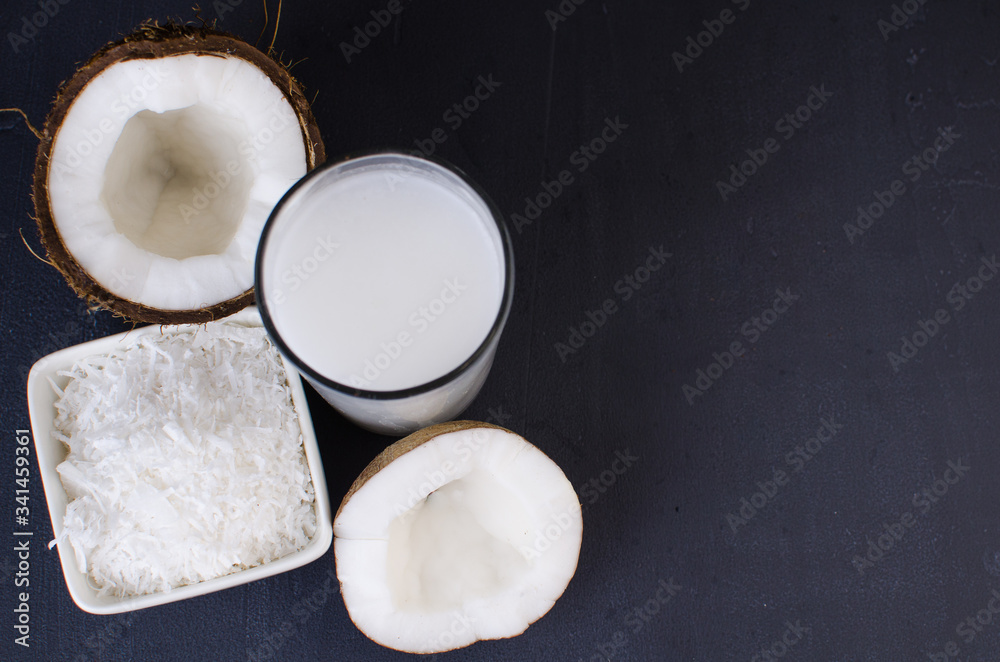 Coconut, coconut shavings and coconut milk on a black background. Coconut, coconut shavings and coconut milk on a black background.