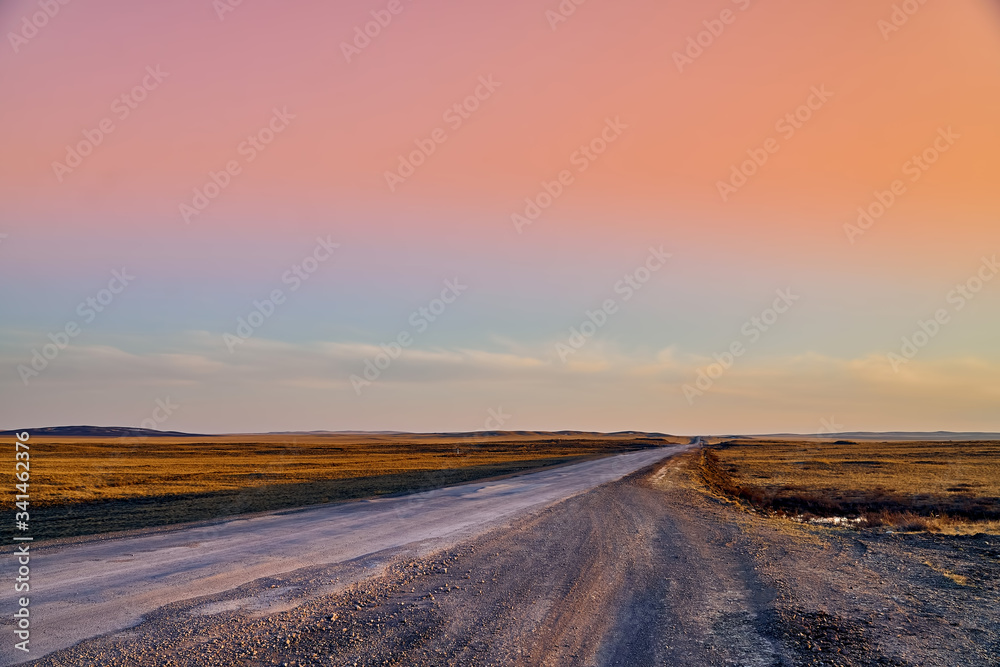 Panoramic view: beautiful spring landscape: spring huge great steppe wakes up from winter sleep - snow and ice just melted, sunset, Kazakhstan