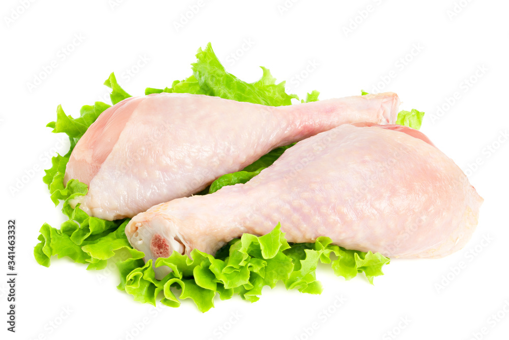 Raw chicken legs and green salad isolated on white background Raw chicken legs and green salad isolated on white background