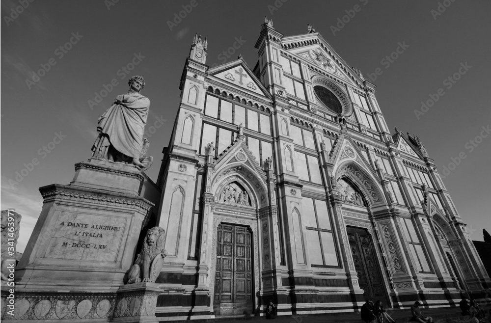 Santa Croce church in Florence, in black and white, with Dante Alighieri statue aside.