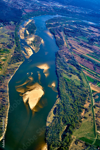 Beautiful panoramic aerial landscape - top view of the Vistula river and fields - view from the window of the plane landing at the Warsaw  Poland  at spring at sunset