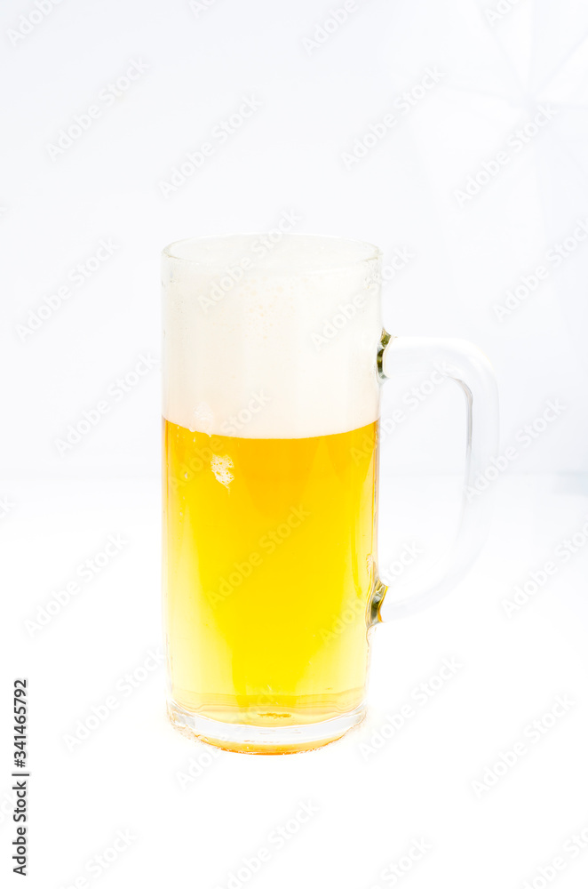 Fresh tasty cold beer with foam in glass on white background. Fresh tasty cold beer with foam in glass on white background.