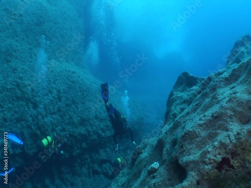 Wallpaper Mural scuba diver underwater exploring the reefs and rocks underwater tunnels and scenery of rocks and landscape ocean scenery Torontodigital.ca