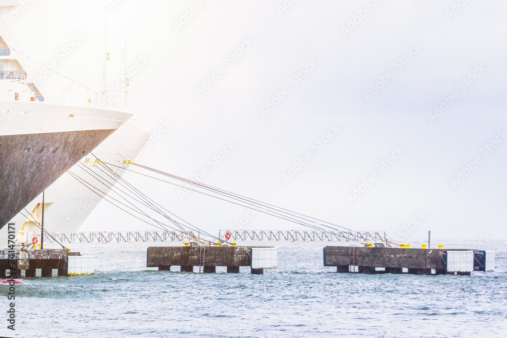 Two cruise ships tied with mooring ropes side be side in the port Two cruise ships tied with mooring ropes side be side in the port