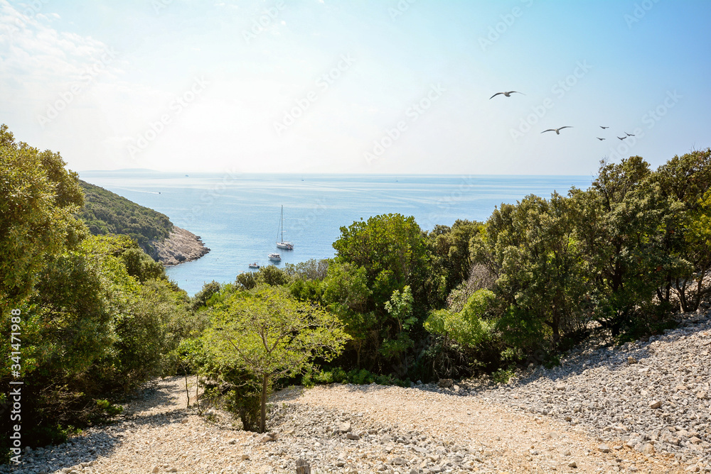 Cres Island, Istria Croatia: View to the beach and sailing boat at adriatic sea near village Valun