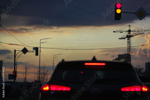 Red traffic light: traffic on the road, urban life