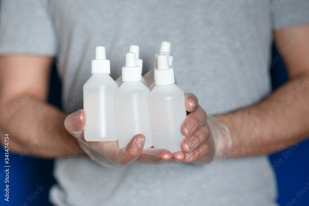 a man wearing gloves with hand sanitizer a man wearing gloves with hand sanitizer