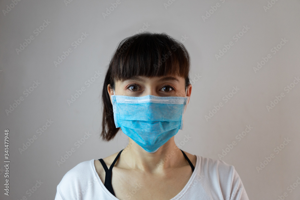 A woman wearing a face mask for prevent dust the spread of germs and bacteria and avoid infections corona virus. Hygiene concept A woman wearing a face mask for prevent dust the spread of germs and bacteria and avoid infections corona virus. Hygiene concept