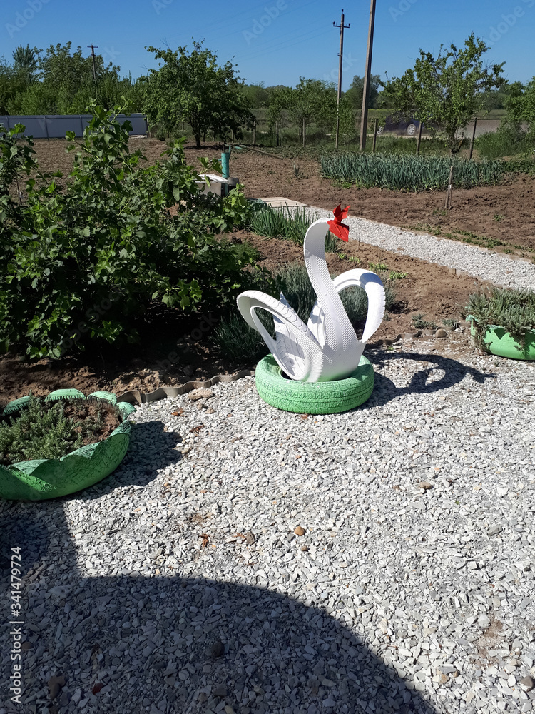 Craft from rubber tire - a white swan. Decorations in the garden.