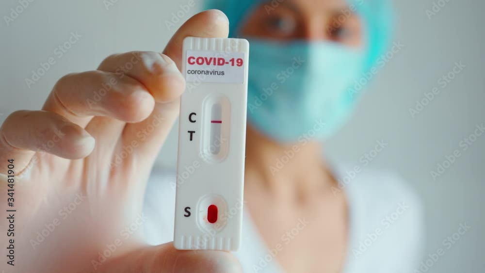 Doctor or nurse in protective face mask and gloves holding lab card kit test for viral disease COVID-19, 2019-nCoV. Test showing negative result. Diagnose coronavirus, Inhibition disease outbreaks. Doctor or nurse in protective face mask and gloves holding lab card kit test for viral disease COVID-19, 2019-nCoV. Test showing negative result. Diagnose coronavirus, Inhibition disease outbreaks.