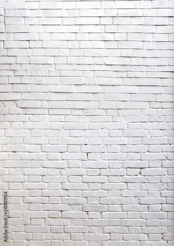 Three- dimensional elements of brickwork on the wall. Terraces on an old brick wall. Old weathered white brick.