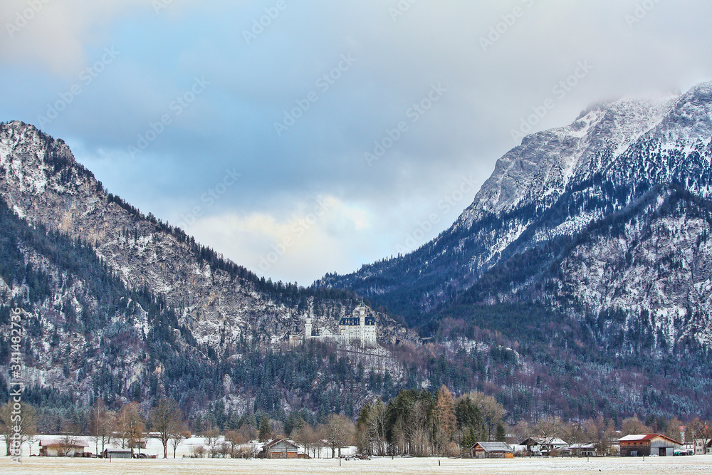 beautiful white Neuschwanstein castle in the Alps mountains