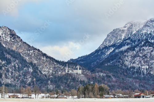 beautiful white Neuschwanstein castle in the Alps mountains