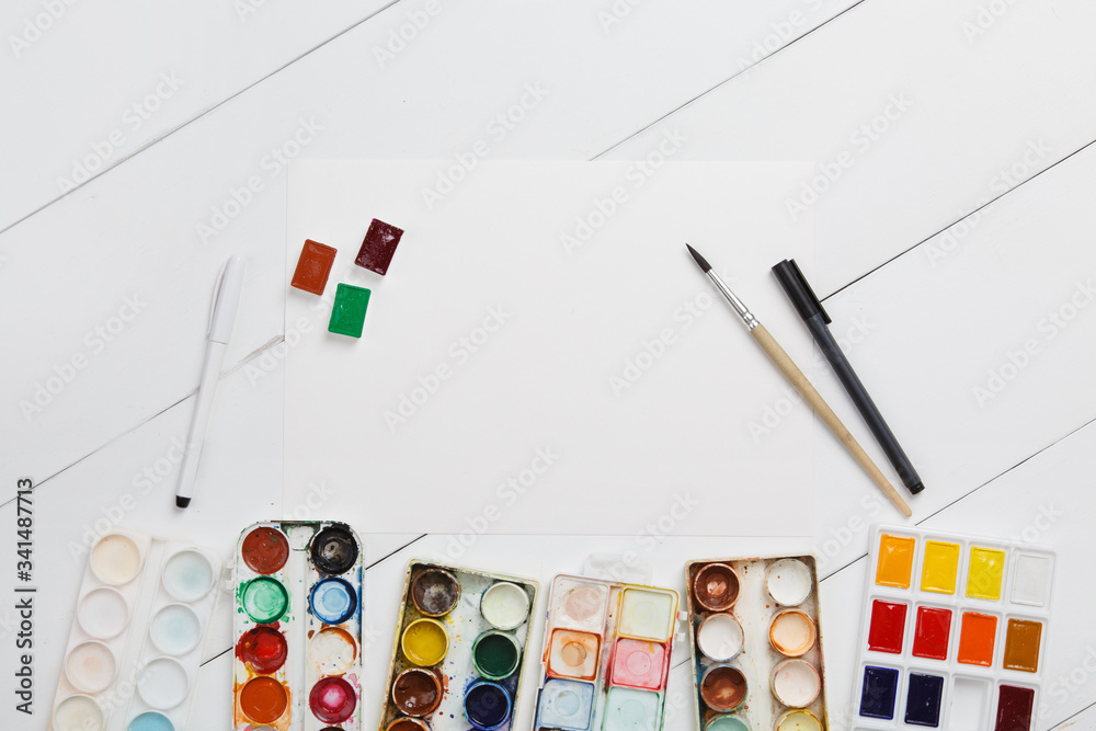 Watercolor painting. Used palette of watercolor paints isolated on white background. art school concept. Colorful Messy Used Paints. Child painter draws a watercolor drawing. Preparing for sketching