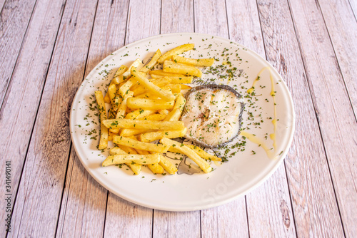 Dish of baked hake with potatoes