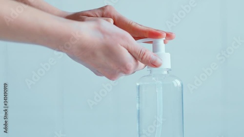 closeup womans hands using liquid gel sanitizer for desinfection at home or laboratory. alcohol gel rub clean hands hygiene prevention of covid-19 coronavirus virus outbreak photo