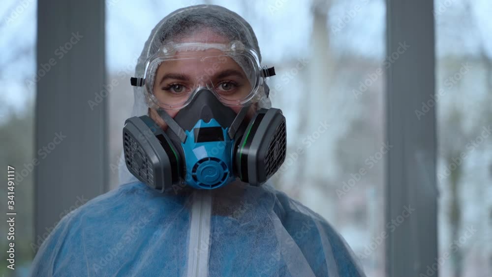 Concept of coronavirus quarantine, global covid-19 epidemic. Treatment of infection. Medic in hazrat protective suit show hands gesture for stop corona virus outbreak Concept of coronavirus quarantine, global covid-19 epidemic. Treatment of infection. Medic in hazrat protective suit show hands gesture for stop corona virus outbreak