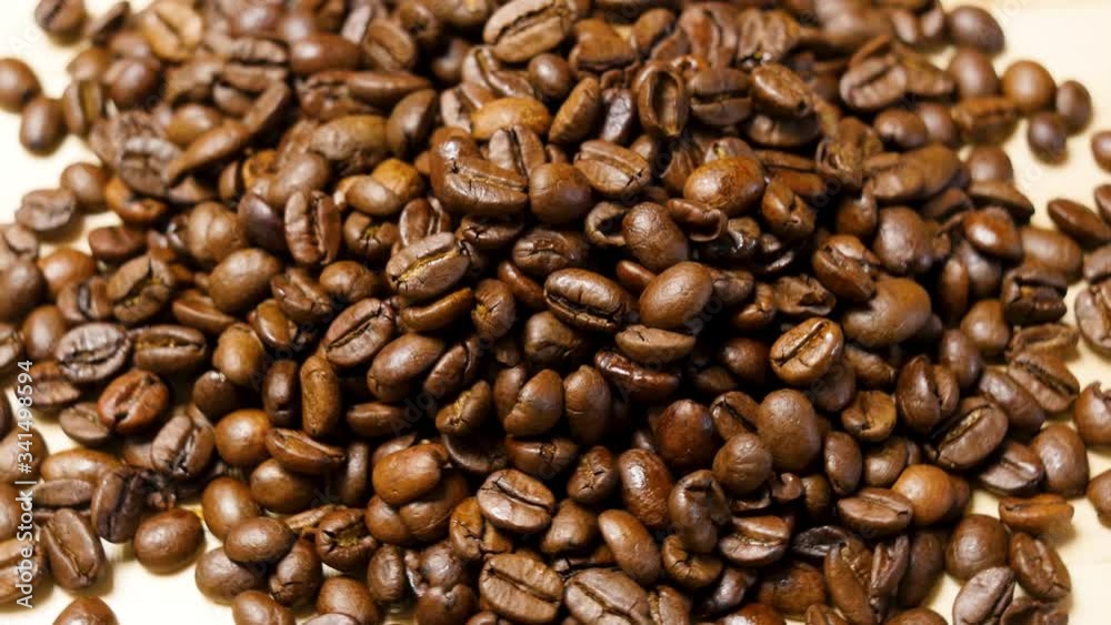 Coffee beans roasted. Close up of seeds of coffee. Macro shot, rotating right. Coffee beans roasted. Close up of seeds of coffee. Macro shot, rotating right.
