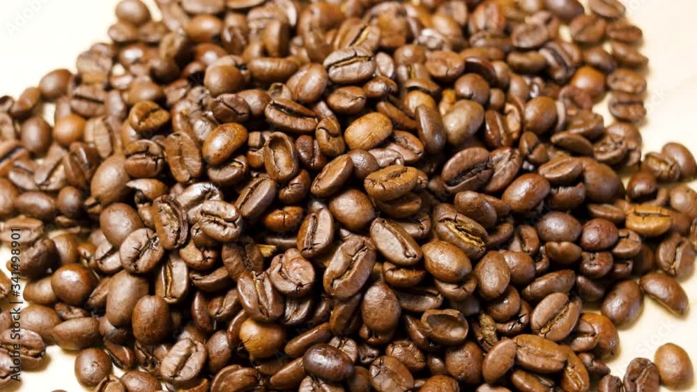 Coffee beans roasted. Close up of seeds of coffee. Macro shot, rotating left. Coffee beans roasted. Close up of seeds of coffee. Macro shot, rotating left.