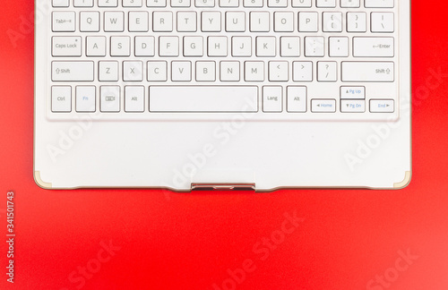 White keyboard isolated on red background.