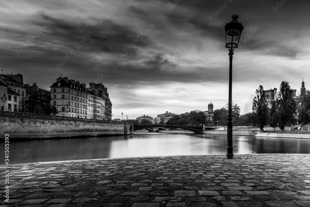 Paris, France - April 21, 2020: Bridges of Paris over Seine River in black and white during lockdown due to covid-19