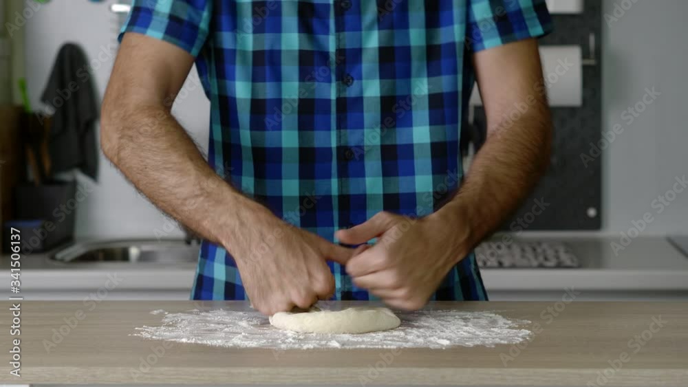 headless torso of a man kneading a small loaf of bread headless torso of a man kneading a small loaf of bread