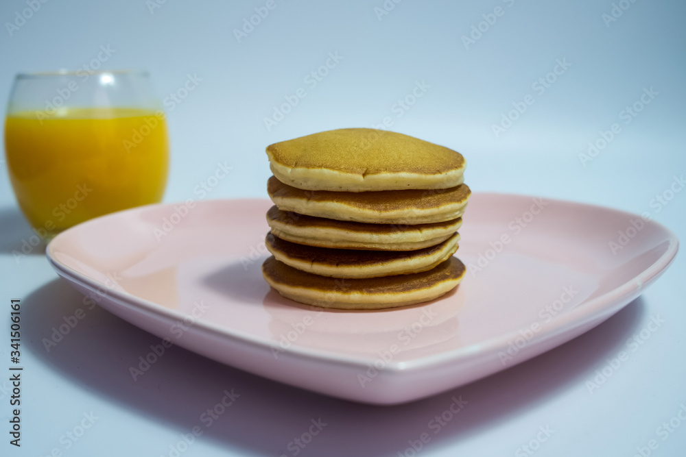 Close-up of stack of delicious fluffy pancakes with fresh strawberries and sugar and honey Close-up of stack of delicious fluffy pancakes with fresh strawberries and sugar and honey