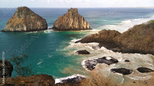 The twins (Dois irmaos), one of the main spots of Fernando de Noronha archipelago, in Brazil. Fernando de Noronha is a national park located 400km of the Brazilian coast. photo