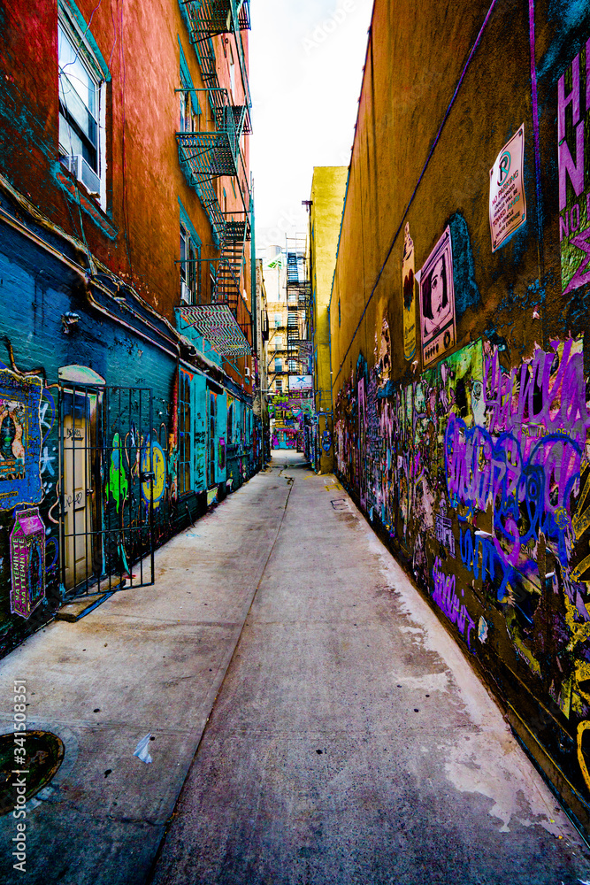 Fototapeta Clean Concrete Alley with graffiti on both sides heavily painted in surreal colors