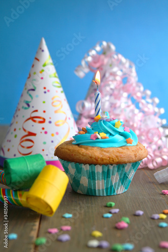 Cupcake with star candles and birthday hats