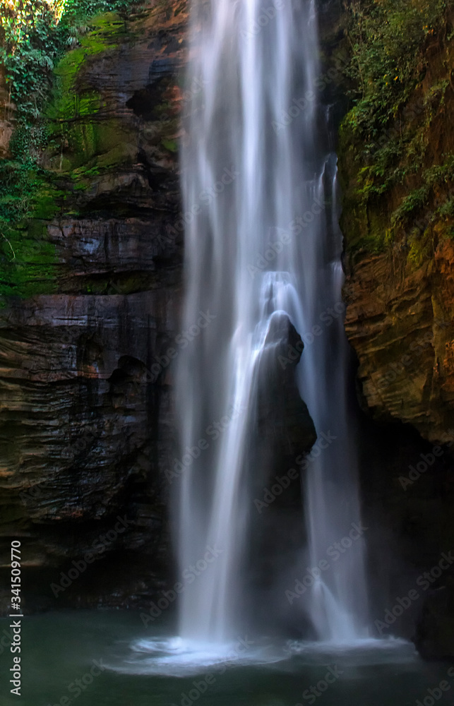 Santa Barbara waterfall in chapada das mesas, Brazil. The rock inside the waterfall reminds of a woman having a shower.
