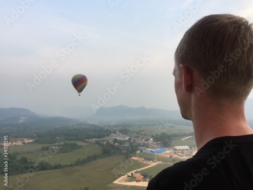 man looking at hot air balloon  