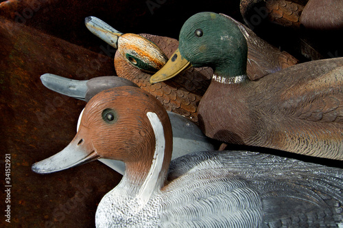 Box full of old hand carved and painted decoy ducks for hunting from bygone era  photo