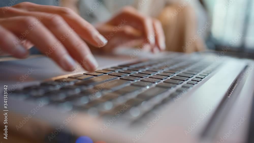 Businesswoman using laptop- close-up. Close-up of female fingers typing laptop keyboard. young woman using laptop at office