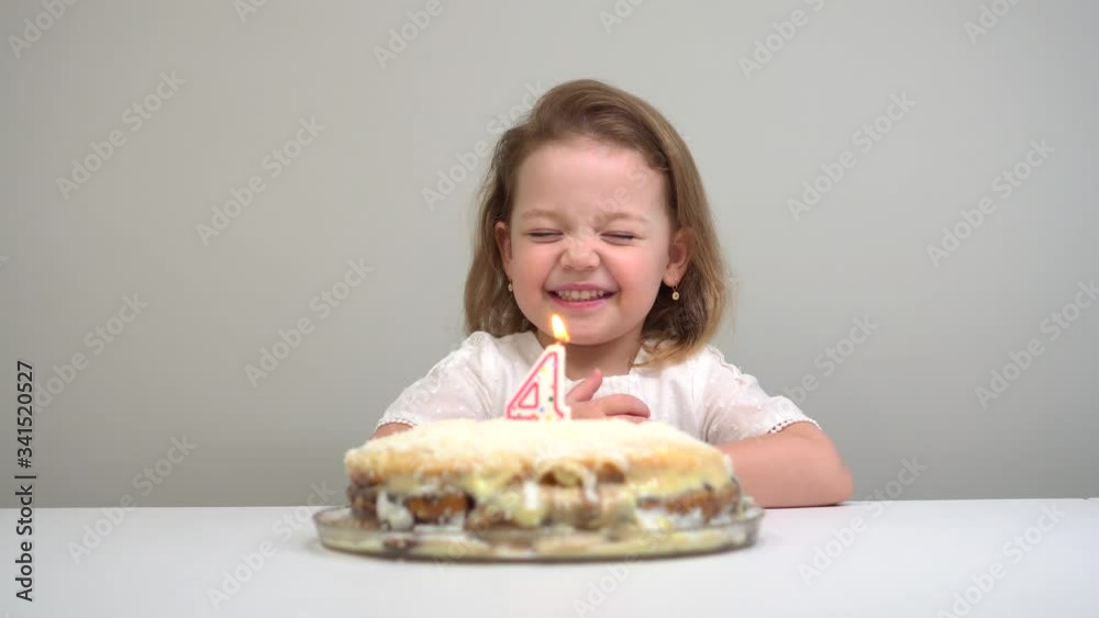 Cute little girl blowing out candles on birthday cake Cute little girl blowing out candles on birthday cake