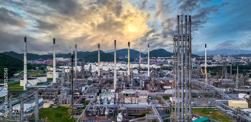 Oil and gas refinery plant and storage tank form industry zone at twilight, Aerial view oil and gas Industrial petrochemical fuel power and energy.