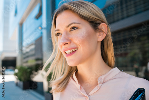 Business woman standing outside office buildings. Free Download Business woman standing outside office buildings. - GFXLoad
