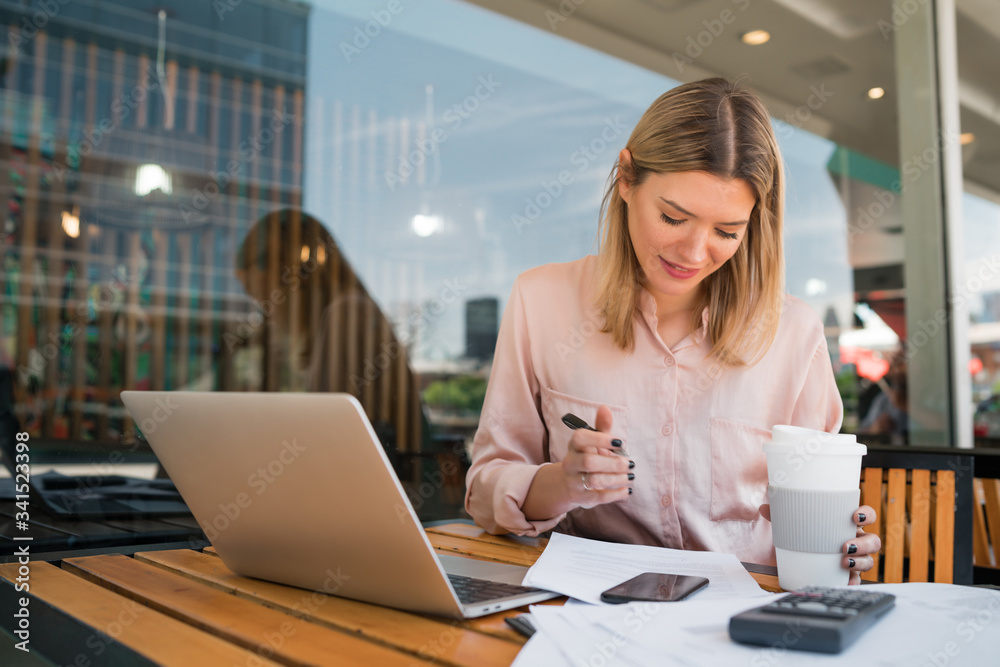 Young businesswoman working on her laptop. Young businesswoman working on her laptop.