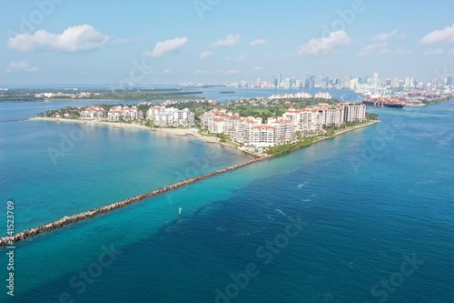 Aerial view of Fisher Island and Government Cut, Florida during COVID-19 stay-at-home order on clear sunny morning.