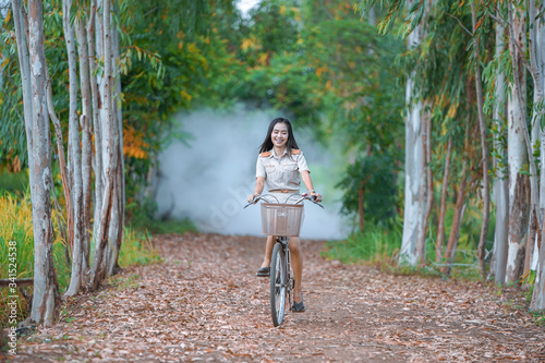 A teacher in a rural school, Cycling to school,Thai teacher in uniform Cycling to school Rural country, Thailand,      
