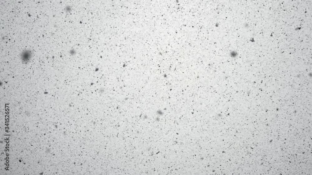 Ash is falling on gray and cloudy sky background