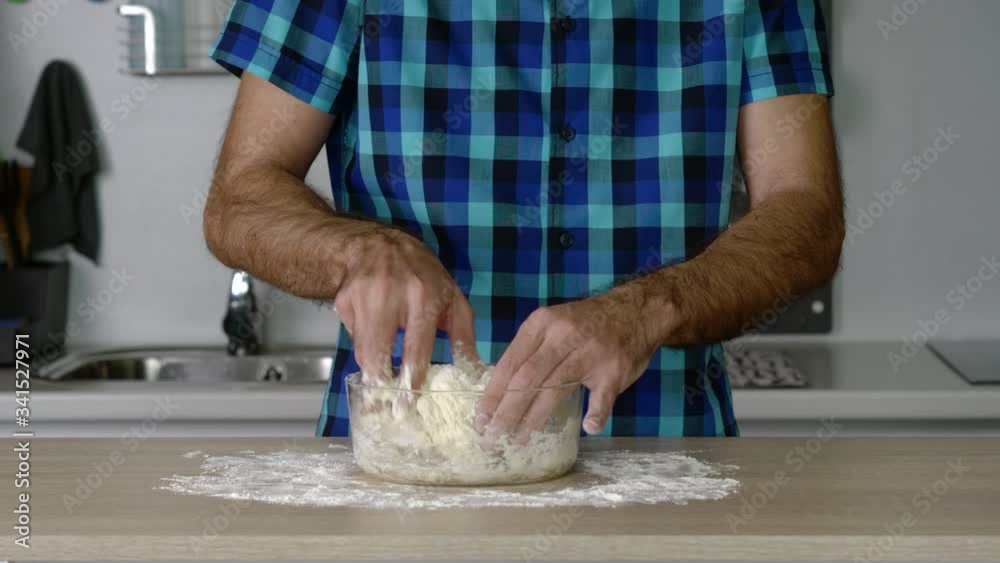 headless torso of a man mixing preparing flour dough headless torso of a man mixing preparing flour dough