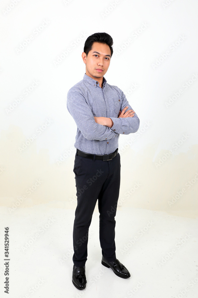 South east Asian Malay Man facial expression confident arms over chest look forward South east Asian Malay Man facial expression confident arms over chest look forward