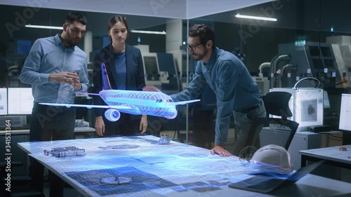 Aeronautics Factory Office Meeting Room: Team of Diverse Engineers and Managers Work on an Augmented Reality Airplane Jet Engine Simulation. Modern Industry 4.0 Research and Development Test. photo