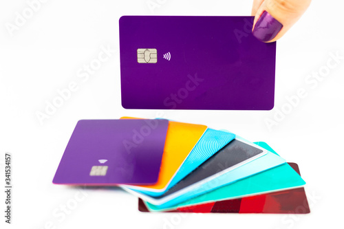Woman holding purple credit card over multiple credit cards