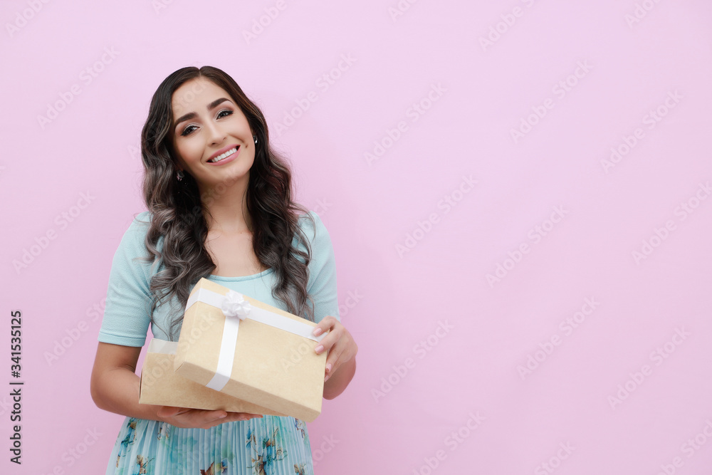 Young woman isolated pink background with gift box Young woman isolated pink background with gift box