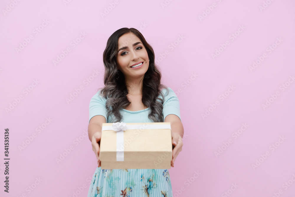 Young woman isolated pink background with gift box