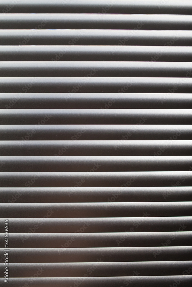 Horizontal blinds. Sunlight coming through venetian blinds by the window. Horizontal blinds. Sunlight coming through venetian blinds by the window.