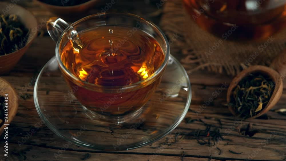 Super Slow Motion Shot of Droplet Falling into Tea at 1000 fps with Still Life Background. Super Slow Motion Shot of Droplet Falling into Tea at 1000 fps with Still Life Background.