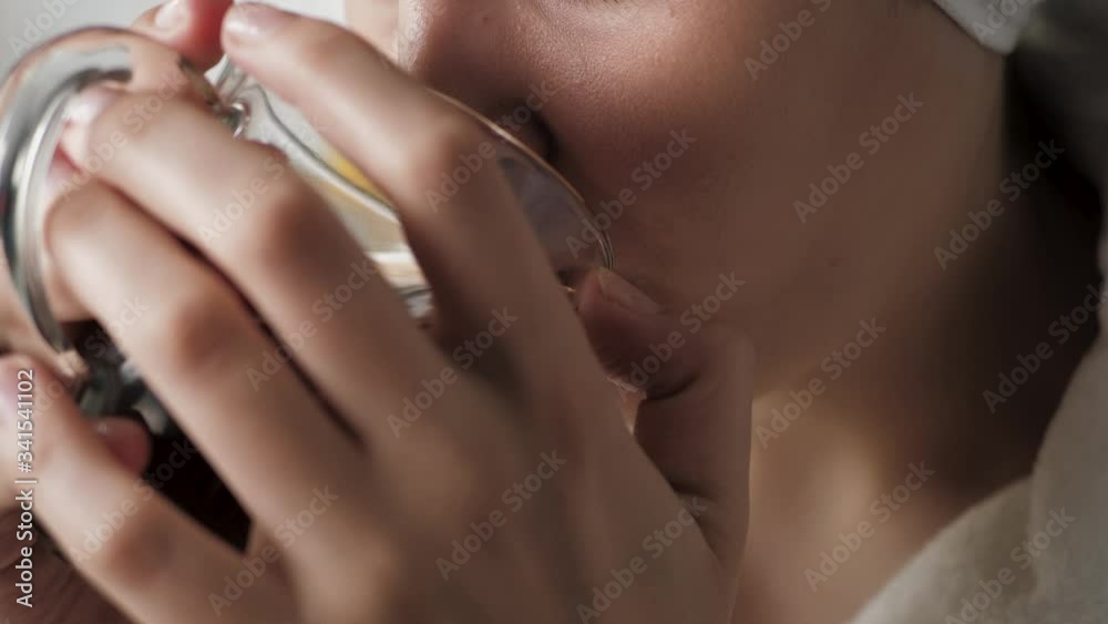 Girl is drinking hot tea. Female hands bring mug of hot tea to their mouth and drink. Close-up Girl is drinking hot tea. Female hands bring mug of hot tea to their mouth and drink. Close-up